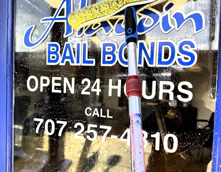 Window cleaning by Green Rose at a commercial storefront